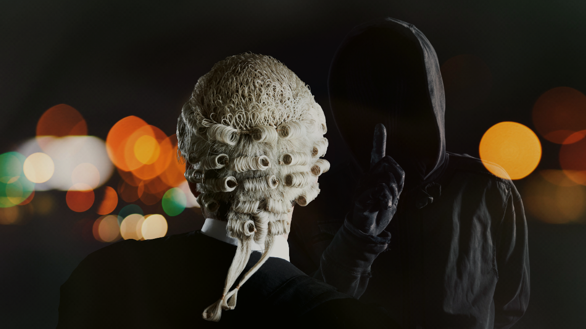Image of a barrister wearing robes and a wig with their back to the camera facing an unidentified hooded figure dressed in black who is gesturing shh with a finger in front of their concealed face.
